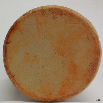 Uneven surface of base has orange-brown discolouration 