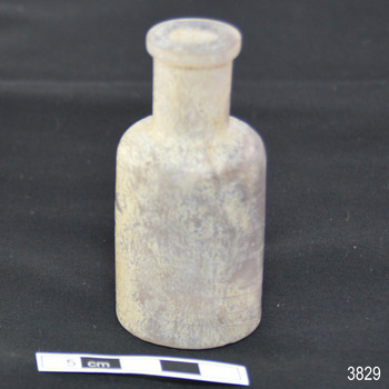 Upright bottle has wide mouth and narrow shoulders
