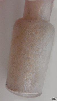 There is residue along one side of the bottle