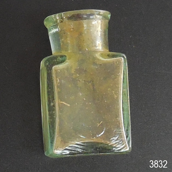 Small clear glass bottle with wide neck and mouth