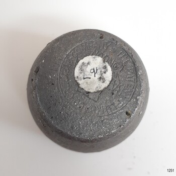 Maker's details are stamped on the base. A white sticker is on the base.