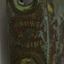 Two formed holes in top. Between them are embossed inscriptions.