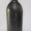 Black glass, cylindrical, bulbous neck. A narrow white line is down one side.