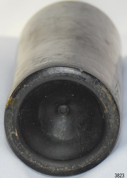 Narrow heel, deep pushed up base, pontil mark in centre. Body has bumpy texture.
