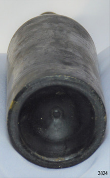 Narrow heel, deep pushed up base, pontil mark in centre. Body has bumpy texture.