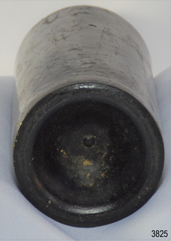 Narrow heel, deep pushed up base, pontil mark in centre. Body has bumpy texture.