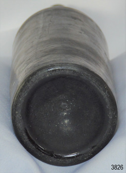 Narrow heel, deep pushed up base, pontil mark in centre. Body has bumpy texture.
