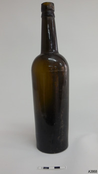 Light shining through shows brown glass. Some horizontal blow-lines around base. Shine on surface.