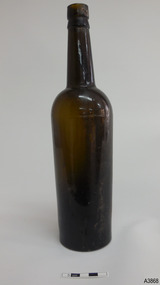 Light shining through shows brown glass. Some horizontal blow-lines around base. Shine on surface.