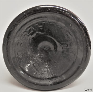 Bottle base has pontil mark and embossing, plus over-embossing.