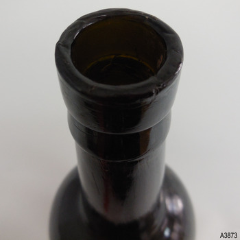 Mouth has chip and is crudely applied. Lip has a double colour; straight upper and flared lower