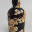 Bottle is covered with cream coloured barnacles