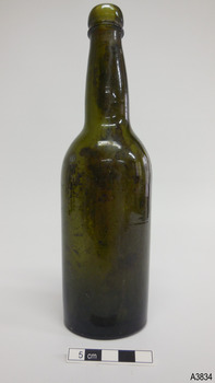 Shiny green glass bottle with mould join around shoulder and blob finish