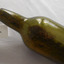 Bibble in lip, sediment, twist lines on shoulder, mould mark below shoulder, rippled glass in base.