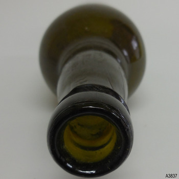 Diagonal line can be seen in neck. Top of lip has imperfections and is roughly made.