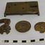 Loch frame and cogs, plus a lever, are on a table. Holes in the fram show where parts were attached.