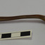 Tablespoon has bowl facing upwards. Metal is a brown colour.