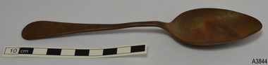 Tablespoon has bowl facing upwards. Metal is a brown colour.