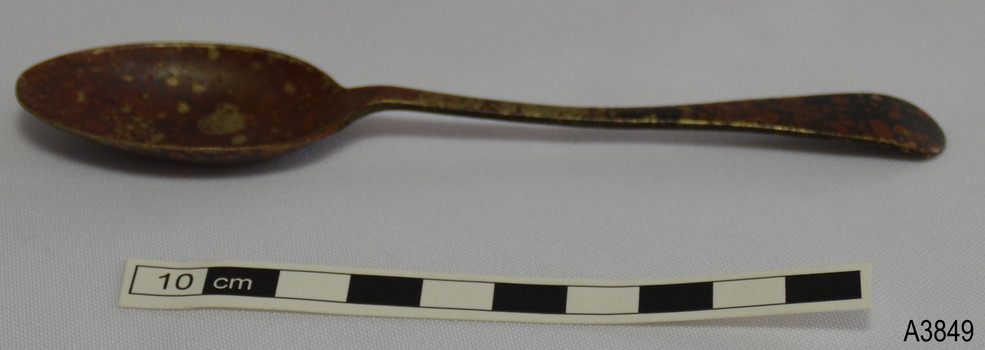 Spoon has deep bowl and rounded end on handle. Metal is discoloured.