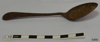 Spoon is dar coloured and bowl is at about 45 degrees angle