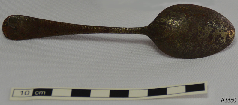 Spoon is brown with remnants of silver. Handle tip has rounded 'M' shepe of Old English design.