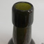 Edge of mouth is uneven, lip is deep and has thin horizontal lines in the glass