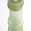 Mouth is uneven, glass has sediment.