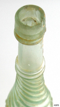 Mouth is uneven, glass has sediment.