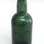 Blue green bottle, tall, sediment inside