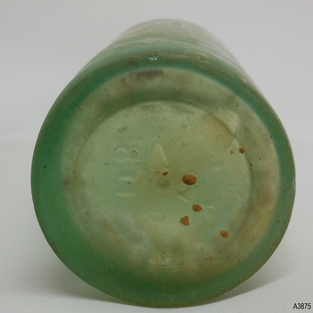 Heel of base has uneven thickness. Centre of base has pontil mark and differs in thickness to the heel. Inscription.