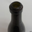Mouth has uneven surface, ring band has straight sides, glass has visible concentric horizontal rings 