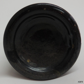 Round base has thick heel, uneven colouring and is shallow