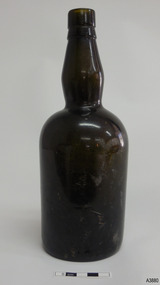 Brown bottle has bulbous neck and wide shoulders, tapering inwards towards base