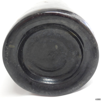 Base has uneven heel and shows imperfections in glass