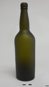 Tall narrow bottle with matt dark green glass