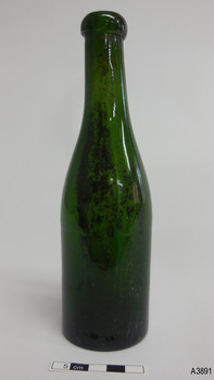 Green bottle is tall and slim with smooth lines and has a blob lip