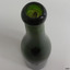 Lip is uneven, neck has horizontal circles within the glass and a long vertical crease line.