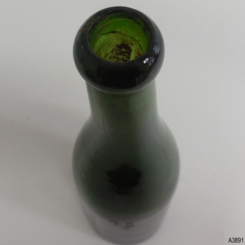Lip is uneven, neck has horizontal circles within the glass and a long vertical crease line.
