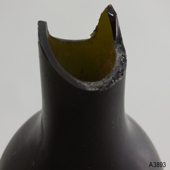 Broken mouth has sharp edges and shows thickness of glass. Neck is hsort.