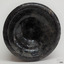 Base has an uneven heal. Surface of glass is bumpy and glass is discoloured. Base is pushed in and there is a pontil mark.