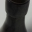 Edge of mouth has a chip. Collar is wide and has concentric rings in the glass. Neck is rippled.