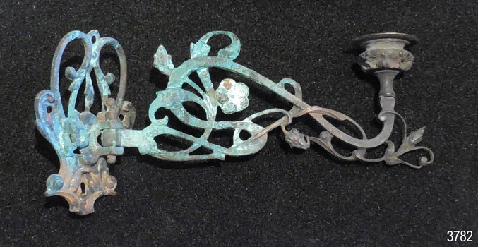 Decorative metal bracket with swivel hinge and candleholder