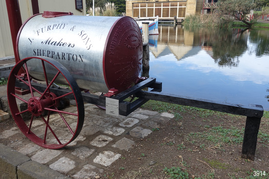 Wheel and tank ends are Painted crimson, shiny metal tank has black inscriptions.