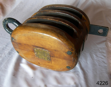 Wooden three-sheave block with metal ring and becket and affixed compliance plate