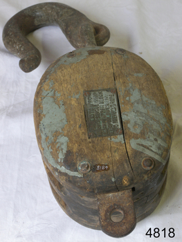 Wooden rope block with metal hook and becket. Compliance plate affixed. 
