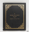 Rectangular book, portrait orientation, black textured cover, embossed gold border, patterned corners, title in gold lettering