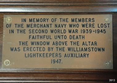 Brass plaque with embossed lettering filled in with black paint