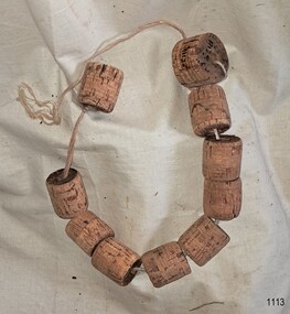 Threaded cork net floats on a bench