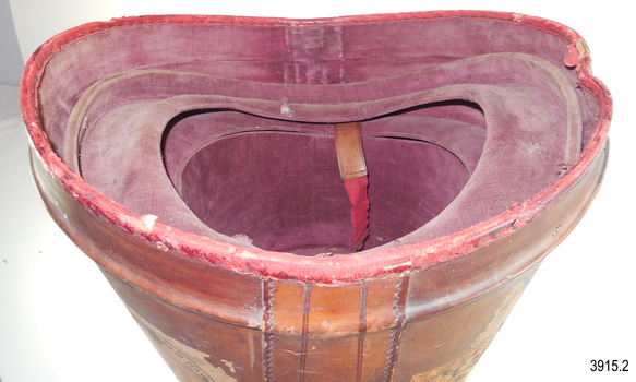 Inner fittings of hat box are visible, showing lining and curved shape of the brim mould