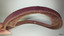 Mould for securing hat brim in box, curved and rimmed to fit the hat's brim.